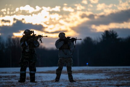 Airmen aim their weapons