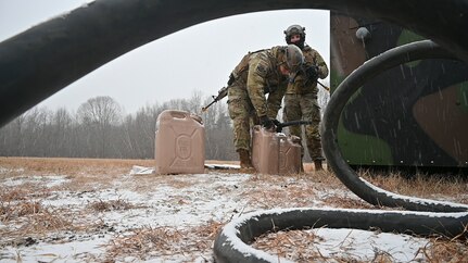 Airmen refuel a generator