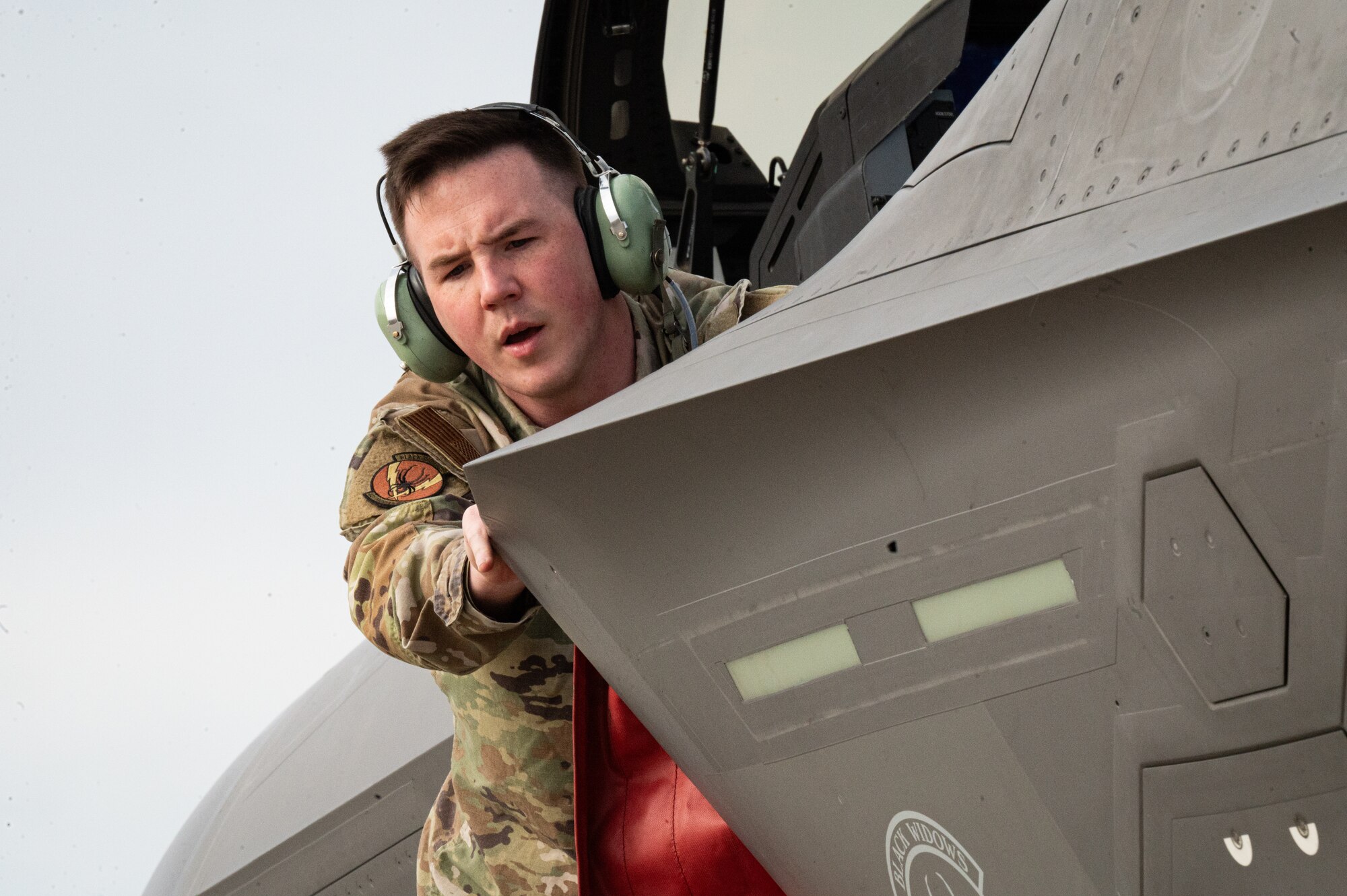 a photo of an F-35 maintainer working with an aircraft