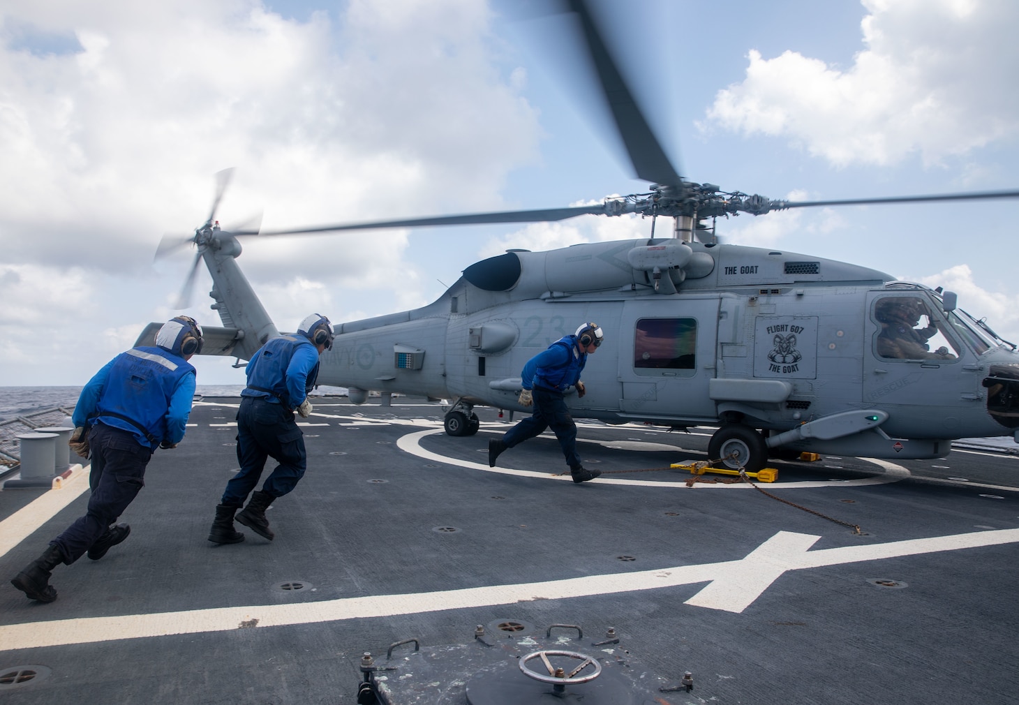 SOUTH CHINA SEA (Feb. 6, 2025) Sailors assigned to the Arleigh Burke-class guided missile destroyer USS Benfold (DDG 65), support flight operations for a Royal Australian Navy MH-60R Seahawk helicopter on Benfold’s flight deck during multilateral operations with Australia and the United Kingdom in the South China Sea, Feb. 6. Benfold is forward deployed and assigned to Destroyer Squadron (DESRON) 15, the Navy’s Largest DESRON and U.S. 7th Fleet’s principal surface force. (U.S. Navy Photo by Mass Communication Specialist 2nd Class Monica Walker.)