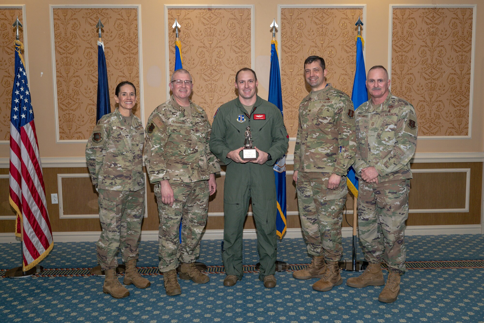 Group of 5 Airmen with center holding Outstanding Field Grade Officer of the Year Award
