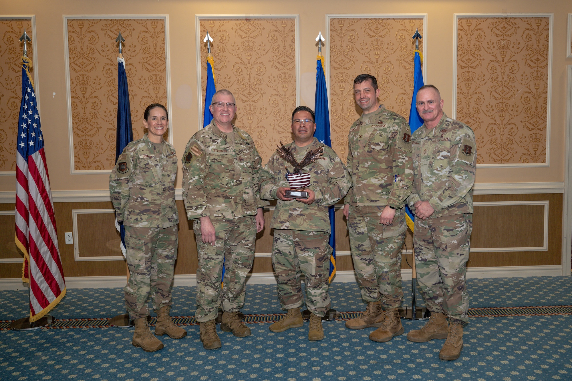 Group of 5 Airmen with center holding 2025 VaANG’s Overall Outstanding Airman of the Year Award.