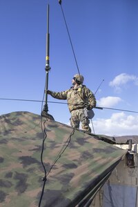 New York Army National Guard Soldiers assigned to Signal Intelligence and Sustainment Company, 42nd Infantry Division, set up radio communication devices Jan. 29, 2025, at Fort Indiantown Gap, Pa. The communication equipment was set up as part of the division’s Warfighter exercise in order to maintain unit readiness. (U.S. Army photo by Sgt. Grace Nechanicky)