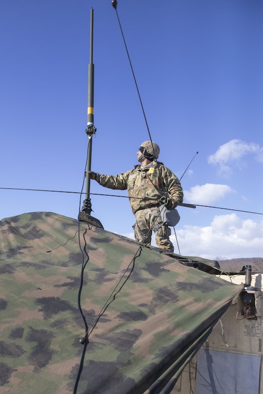 New York Army National Guard Soldiers assigned to Signal Intelligence and Sustainment Company, 42nd Infantry Division, set up radio communication devices Jan. 29, 2025, at Fort Indiantown Gap, Pa. The communication equipment was set up as part of the division’s Warfighter exercise in order to maintain unit readiness. (U.S. Army photo by Sgt. Grace Nechanicky)