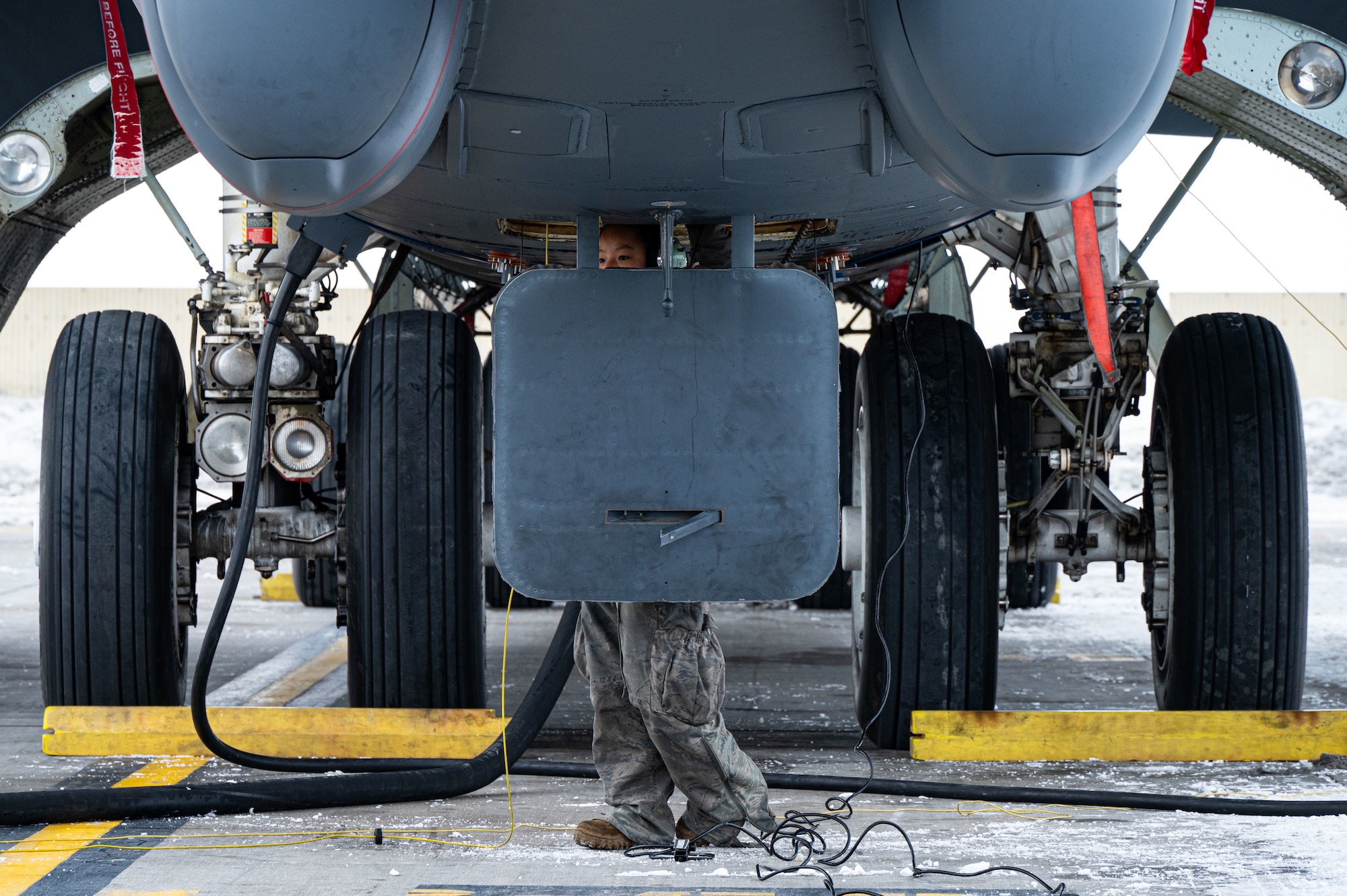 Senior Airman Lily Nicholson, B-52H crew chief apprentice assigned to the 5th Aircraft Maintenance Squadron (5th AMXS), conducts a B-52H Stratofortress refuel at Minot Air Force Base, North Dakota, Jan. 29, 2025. The 5th AMXS Airmen refuel aircraft and ground vehicles, as well as ensure the quality of the fuel. (U.S. Air Force photo by Airman 1st Class Padilla)