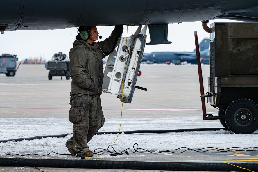 Senior Airman Lily Nicholson, B-52H crew chief apprentice assigned to the 5th Aircraft Maintenance Squadron (5th AMXS), conducts a B-52H Stratofortress refuel at Minot Air Force Base, North Dakota, Jan. 29, 2025. The 5th AMXS Airmen refuel aircraft and ground vehicles, as well as ensure the quality of the fuel. (U.S. Air Force photo by Airman 1st Class Padilla)