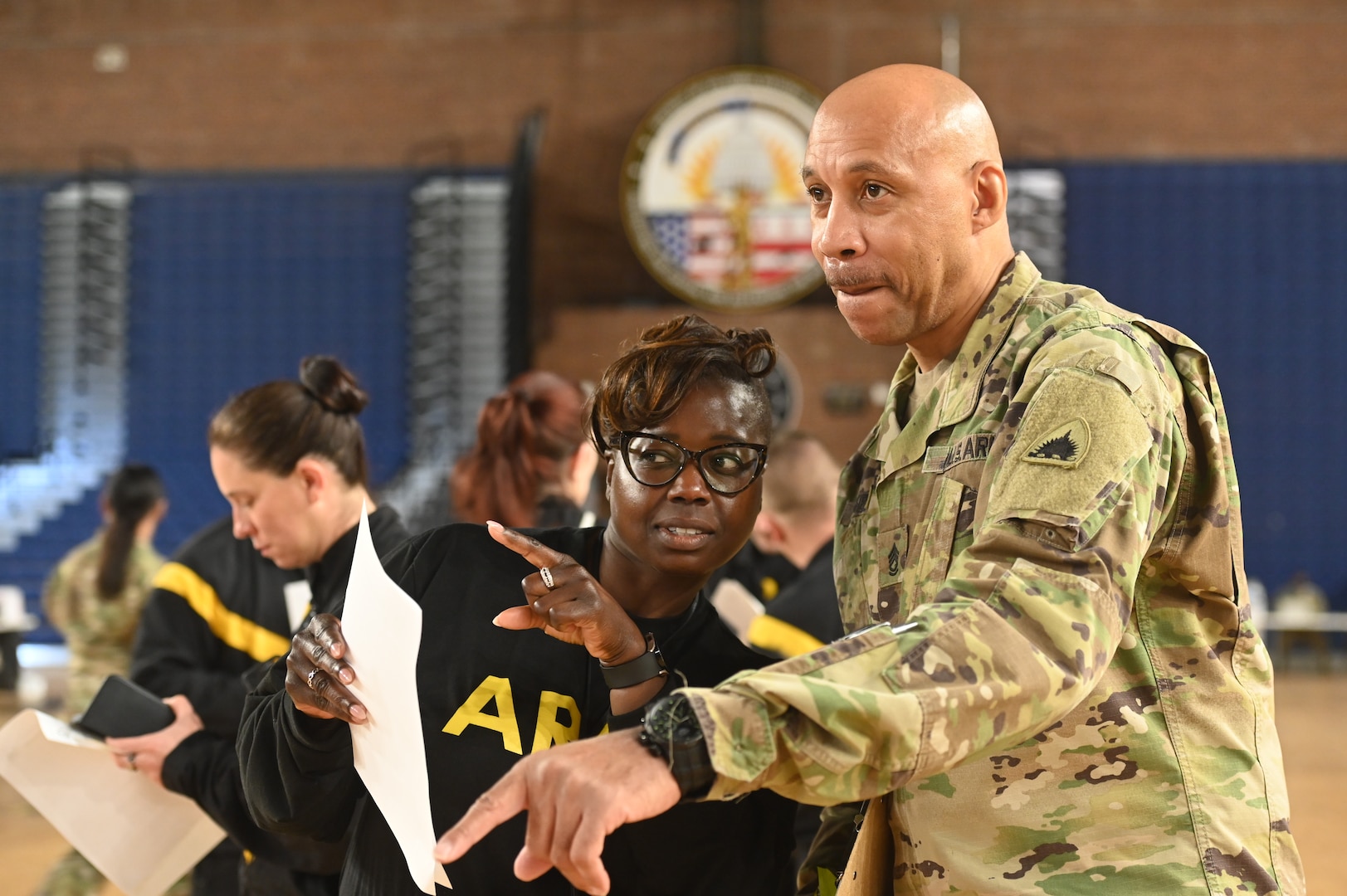 U.S. Army SFC Richard Hughes, Senior Enlisted Leader for the D.C. Army National Guard's (DCARNG) Medical Detachment, provides guidance to CSM Mariatu Koroma, MAC Command Sergeant Major-Supervisory Auditor, during Soldier Readiness Processing (SRP), and the Periodic Health Assessments (PHA), at the D.C. Armory, Nov. 3, 2024. Coordinated by the D.C. Army National Guard Medical Detachment, these annual health exams for Guardsmen are held at the D.C. Armory and they ensure that all servicemembers meet the physical and medical requirements necessary for deployment and operational support.