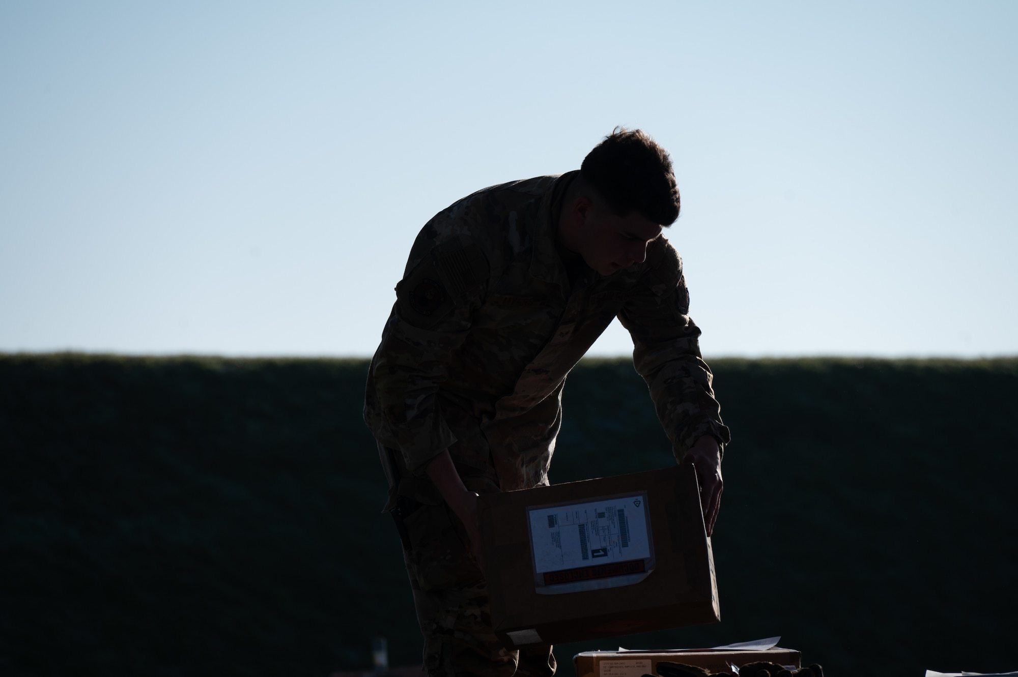 A Pathfinder from the 420th Munitions Squadron moves a box to a truck on RAF Welford