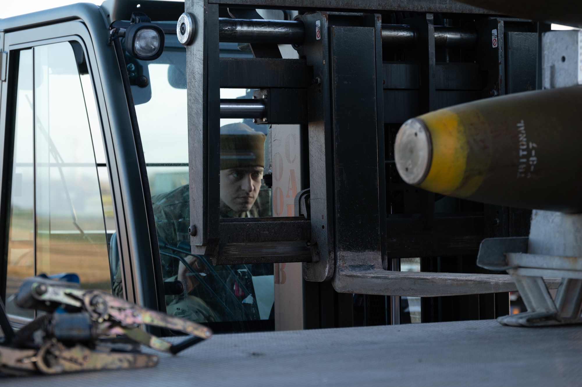 U.S. Air Force Senior Airman Braedon Naramore, 420th Munitions Squadron shipping and receiving technician, uses a forklift to carry munitions