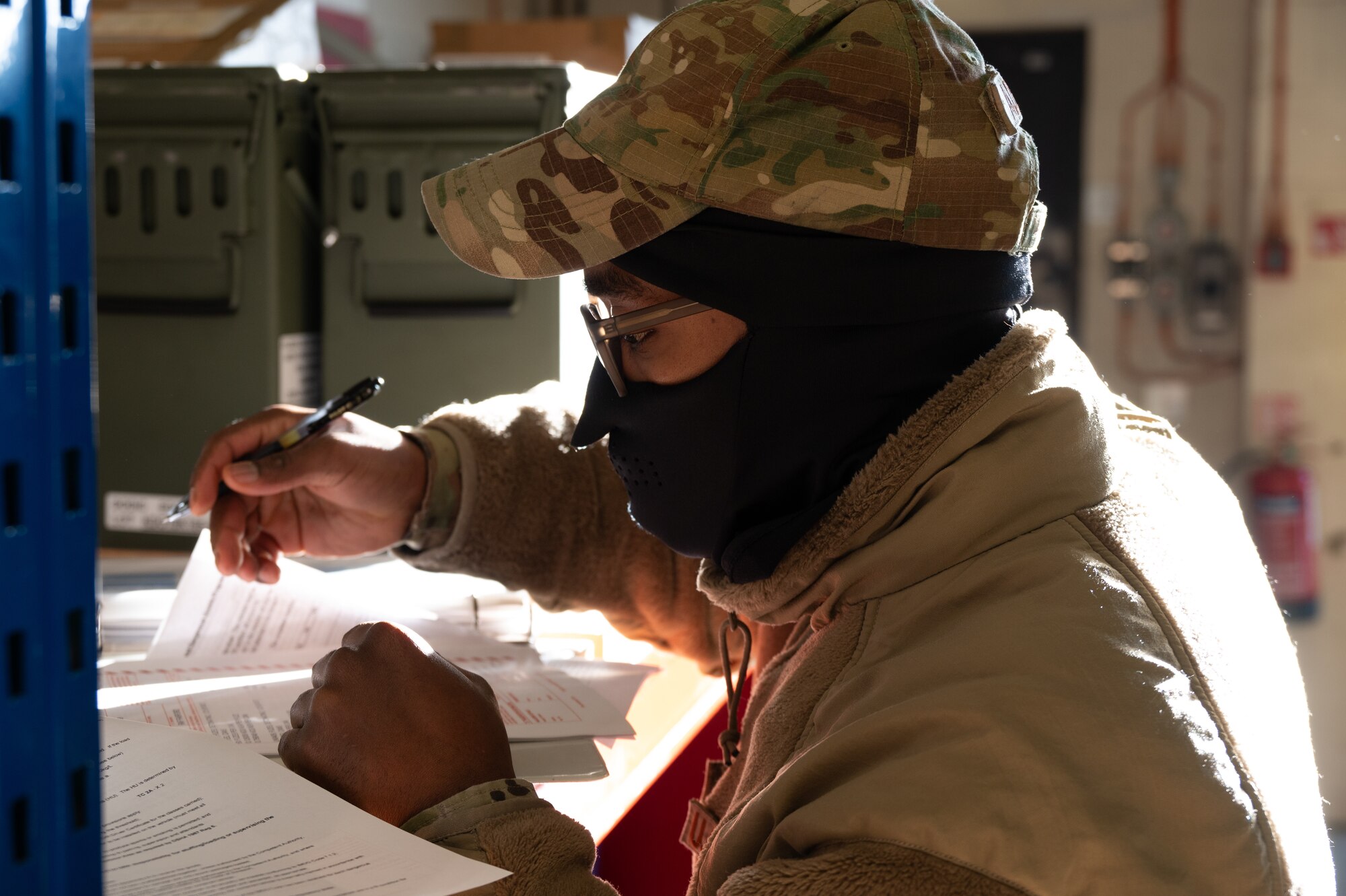 U.S. Air Force Staff Sgt. Brice Asha Eliam, 420th Munitions Squadron munitions controller, fills out paperwork