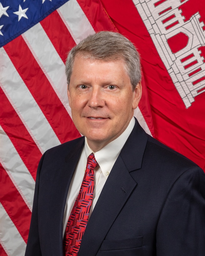 Profile Picture on a man in front of a flag.