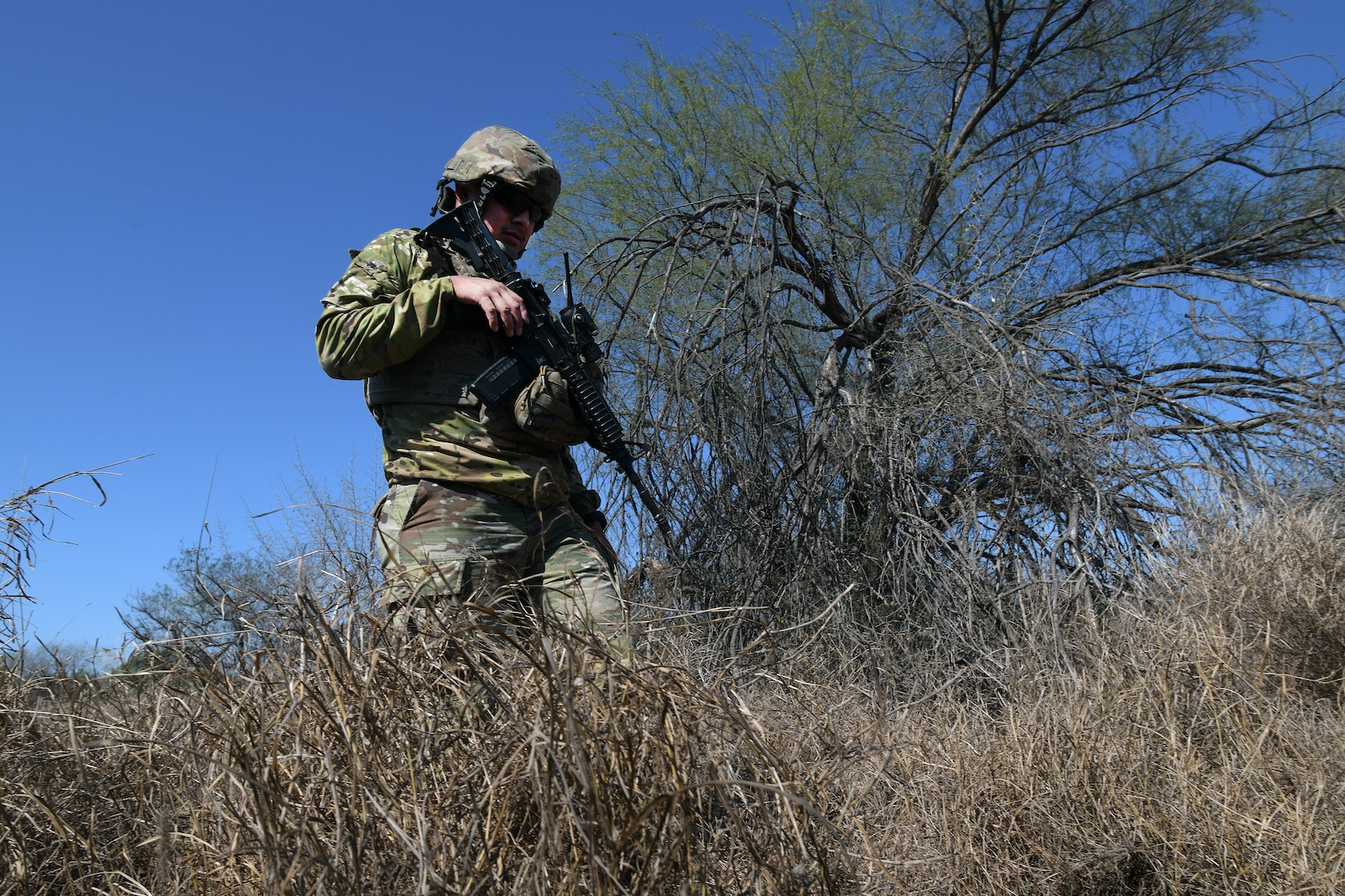 Texas Army National Guard Spc. Marc Lopez checks for migrant activity and evidence of illegal border crossings in a wooded area along the southern border near McAllen, Texas, as part of the Texas Tactical Border Force Feb. 03, 2025. The TTBF comprises Texas National Guard members in state active duty status who work with state and federal law enforcement officials, including U.S. Border Patrol, to deter, detect and stop illegal border crossings and to interdict transnational criminals.