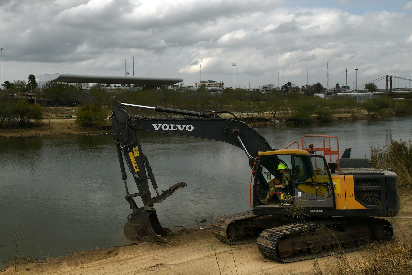 A Texas Army National Guard Soldier assigned to the Texas Tactical Border Force clears brush and shores up the edge of a path along the U.S. side of the Rio Grande River near Roma, Texas, to aid U.S. Border Patrol's ability to move throughout the area and monitor for illegal border crossings Feb. 5, 2025.