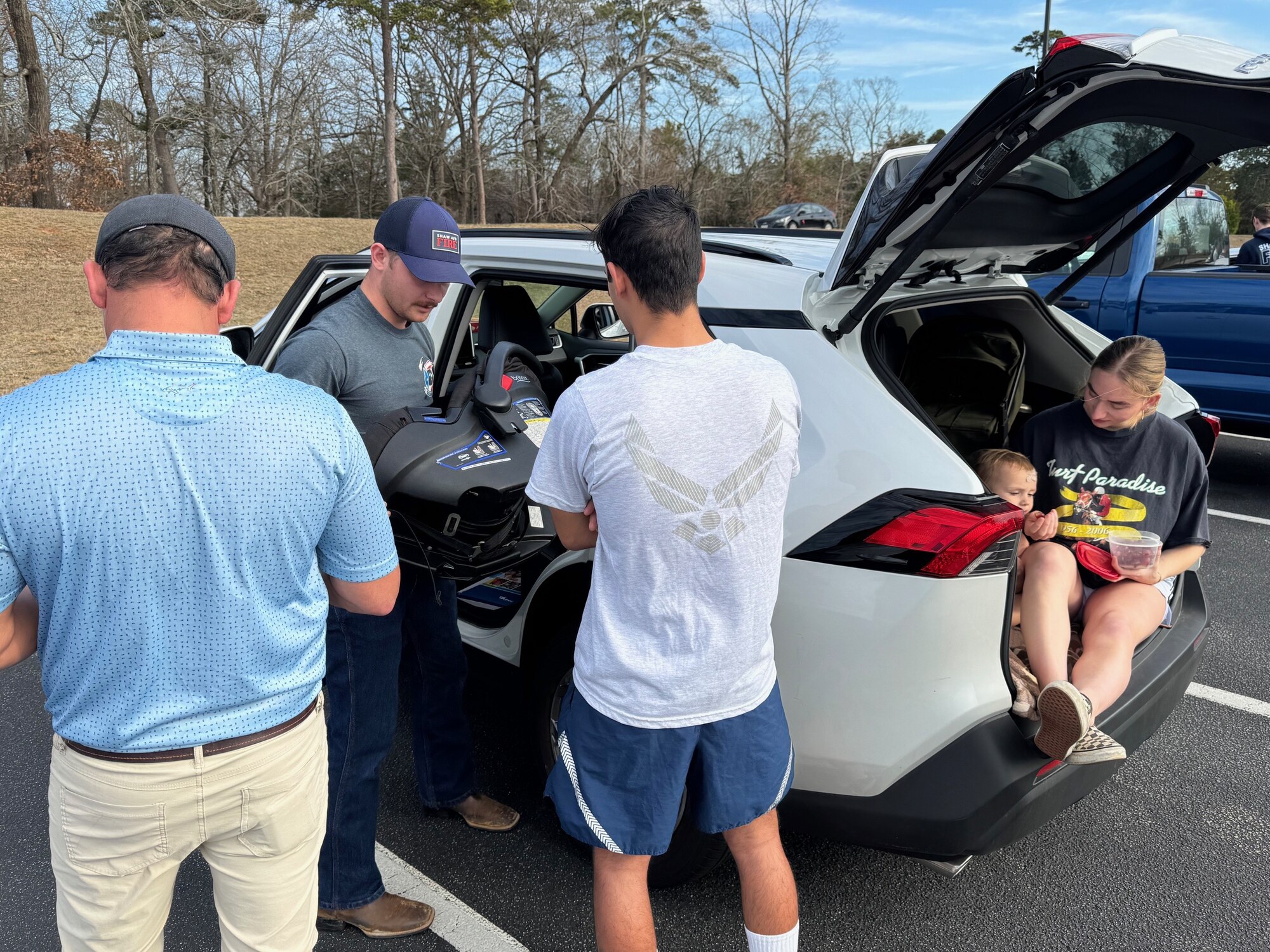 U.S. Air Force Senior Airman Jared Ferguson, 20th Civil Engineer Squadron Fire and Emergency Services operator, center, inspects a car seat at Shaw Air Force Base, S.C., Jan. 31, 2025. Ferguson, along with 15 other personnel from the 20th CES FES, Lexington Fire, Dorchester County Fire, Lexington and Sumter County Sheriff’s Office, and Prisma Health, was added to the ranks of the 1,100 current Child Passenger Safety Technicians in the state of South Carolina. (Courtesy photo)