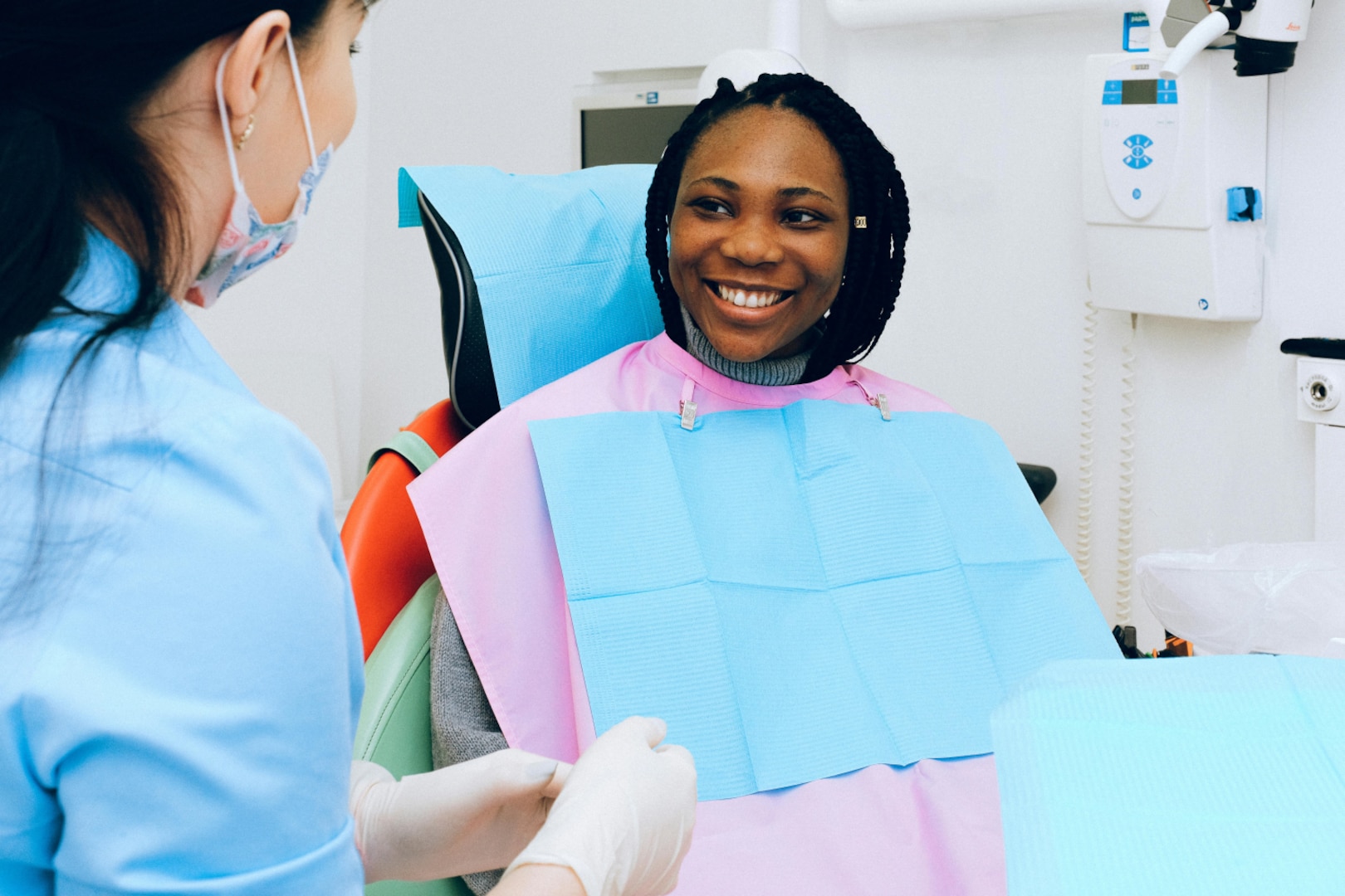 Young woman smiles at dentist in dental chair