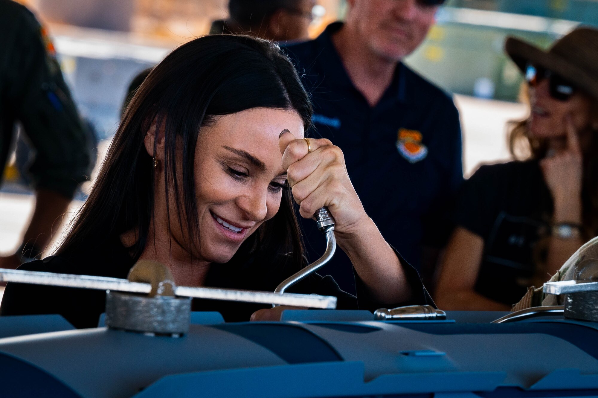 Hannah Marshall, 56th Operations Support Squadron honorary commander, secures a bolt on ammunition during an immersion tour.
