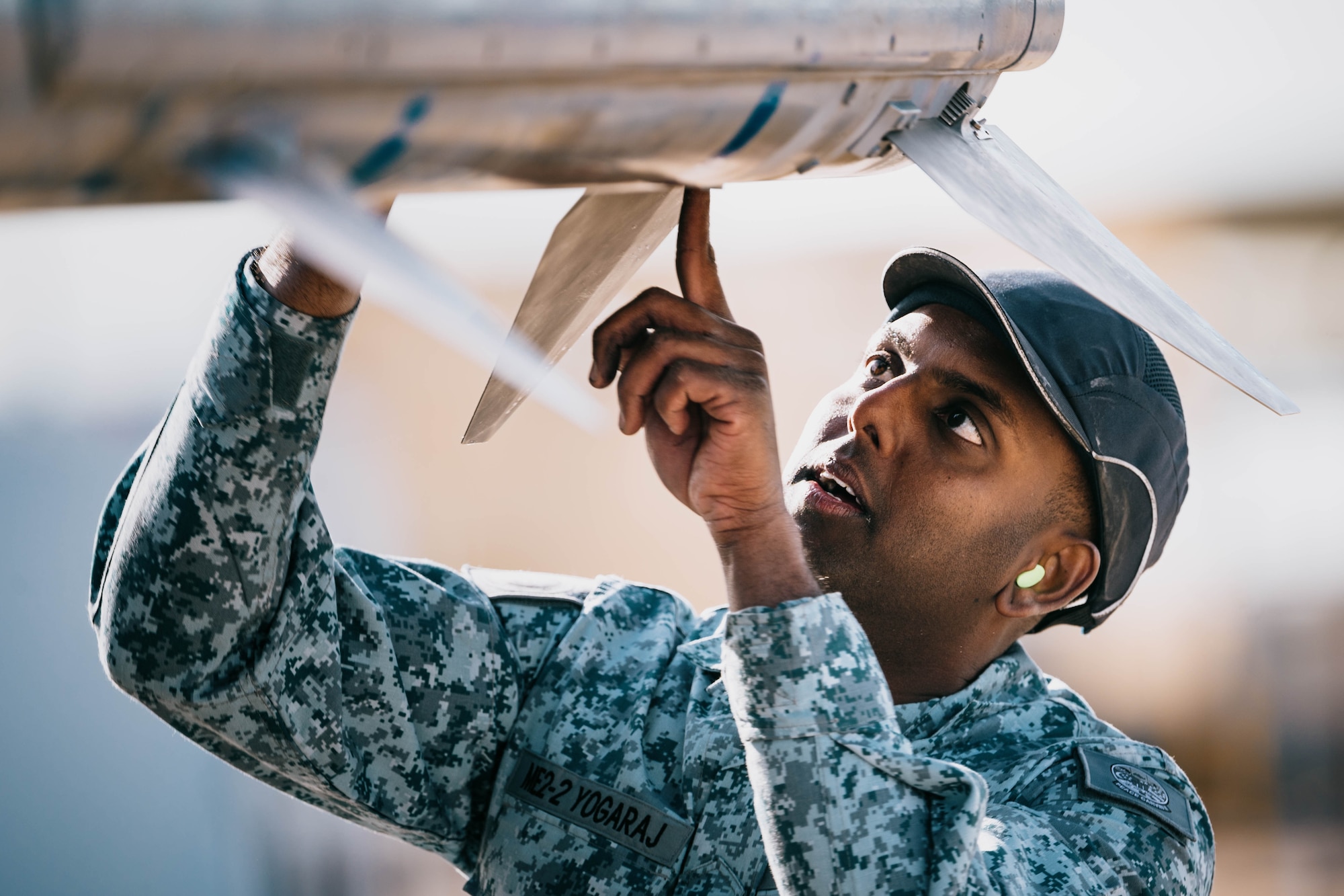 Republic of Singapore Air Force ME2 Kunaseelan Yogoraj, 425th Fighter Squadron weapons load crew member, prepares an AIM-120 Advanced Medium-Range Air-to-Air Missile bomb.