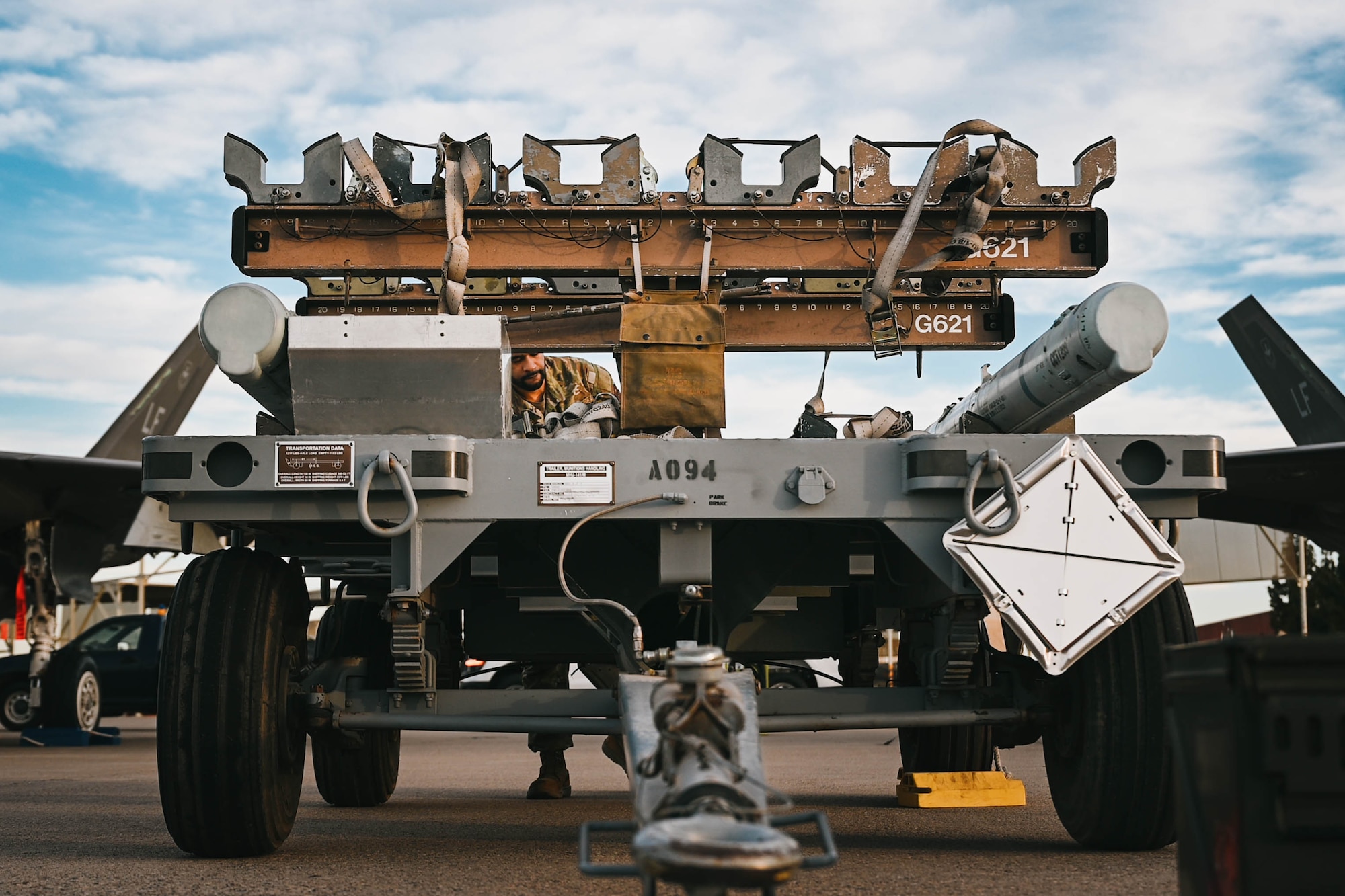 U.S. Air Force Tech. Sgt. Jacob Wigfall, 56th Maintenance Group loading standardization crew member, prepares an MHU-141 trailer.
