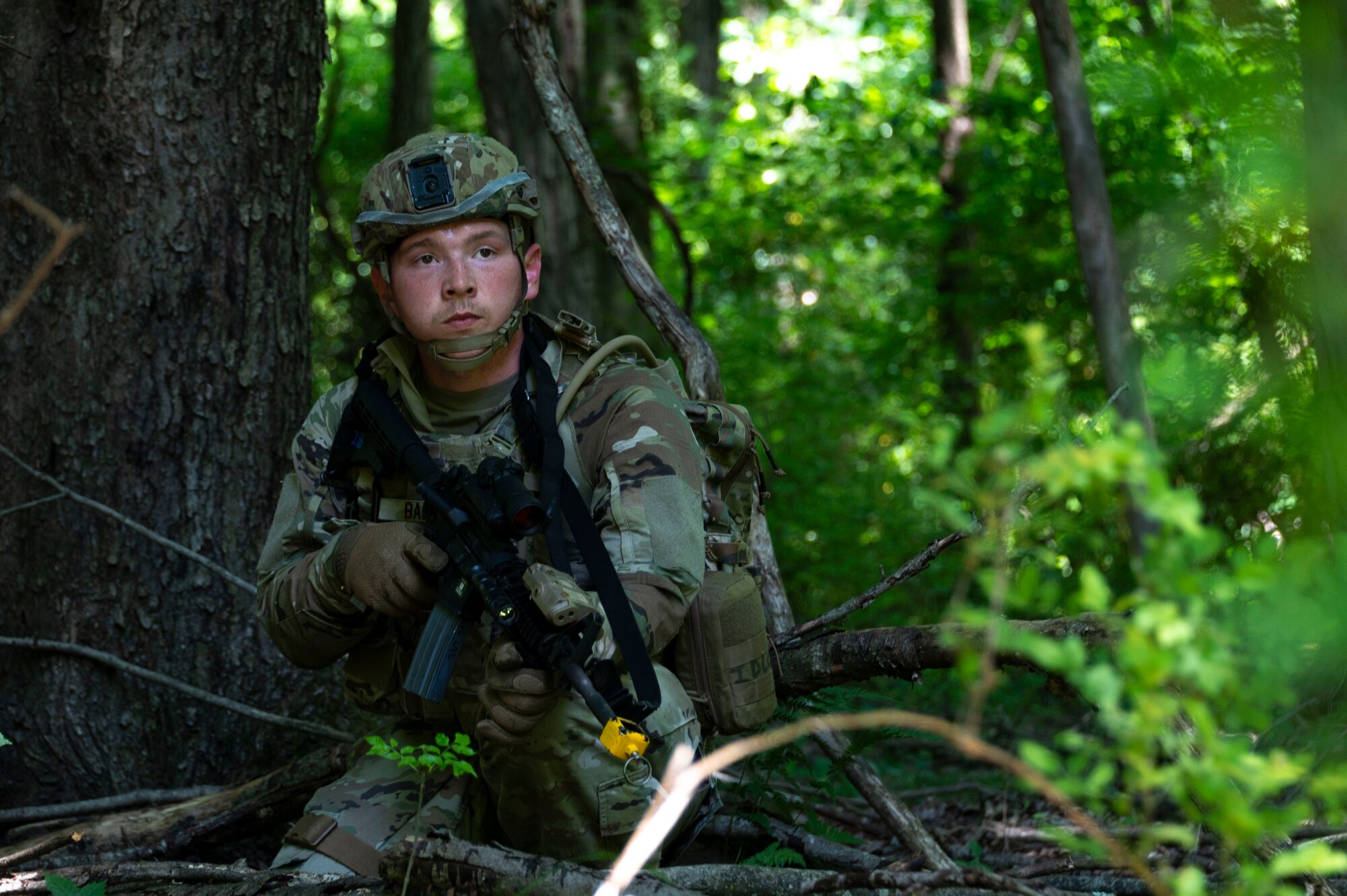 An Airman carries a rifle on maneuvers.
