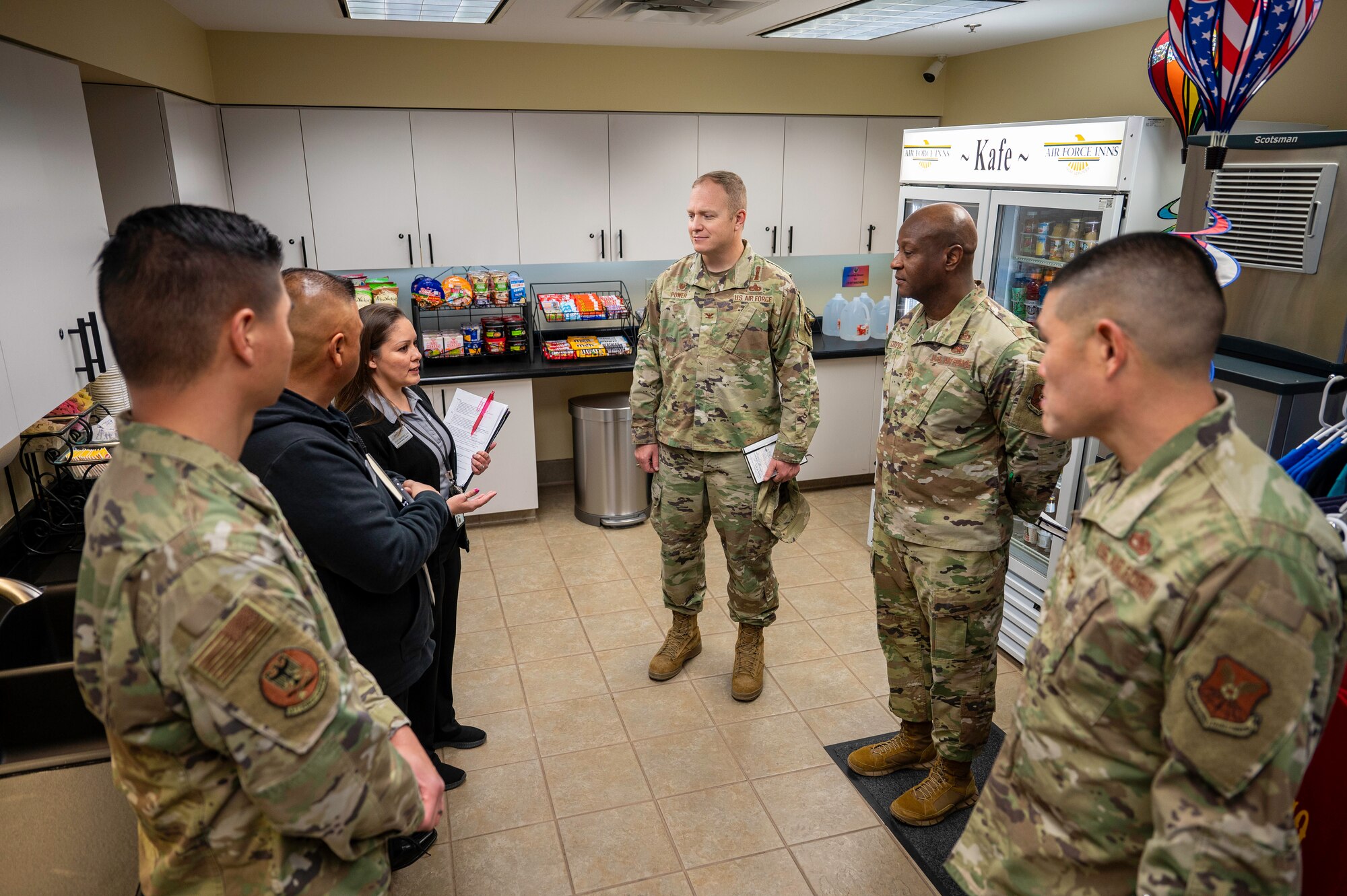 Leadership from the 377th Air Base Wing speak with staff members at the Roadrunner Inn during a lodging tour at Kirtland Air Force Base, N.M., Feb. 10.