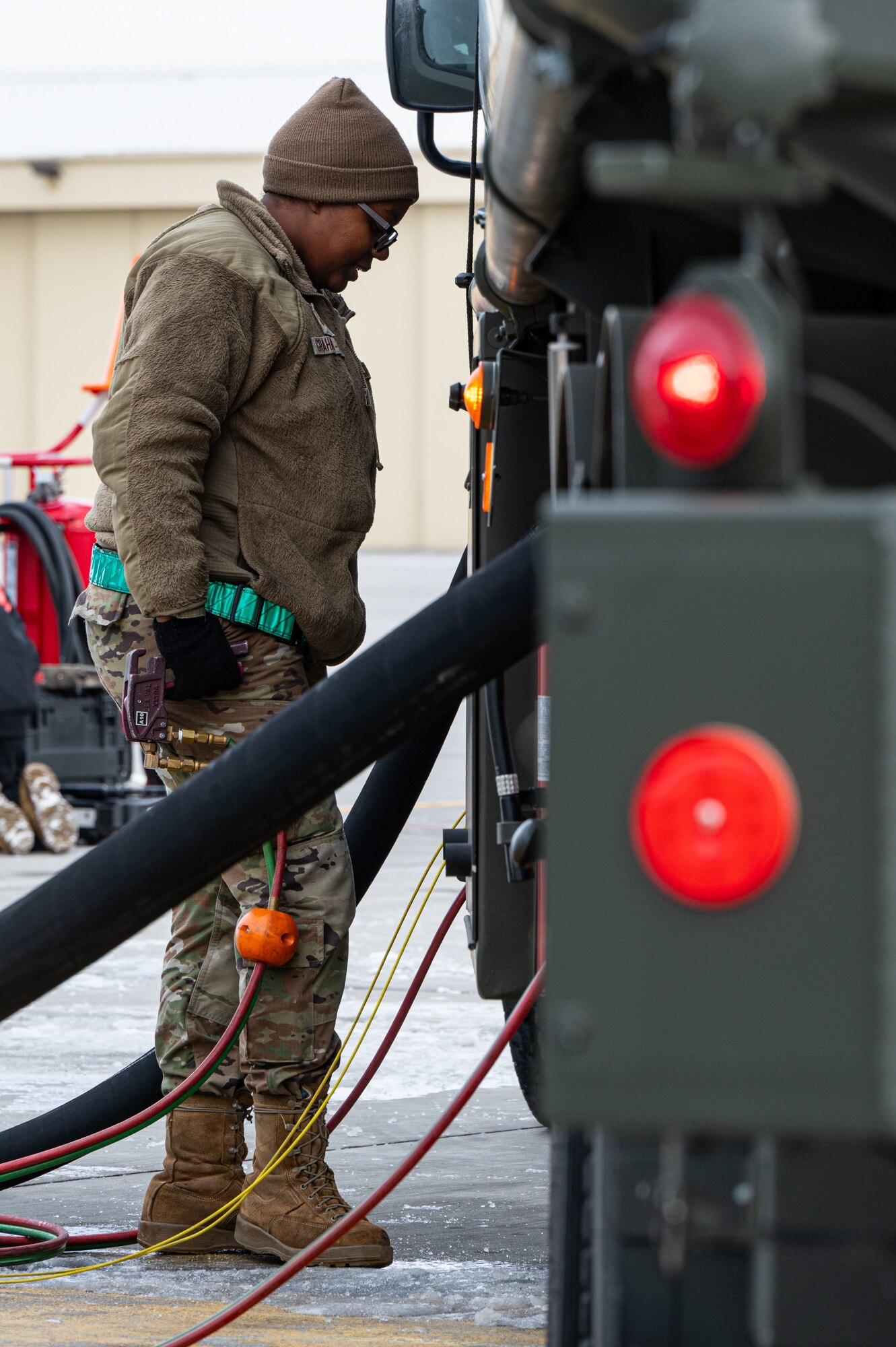 Senior Airman Nichelle Graham-Mahuka, a 5th Logistic Readiness Squadron fuels distribution operator, delivers fuel to an aircraft at Minot Air Force Base, North Dakota, Jan. 29, 2025. Petroleum, oil and lubricant distribution operators manage refueling trucks to supply fuel to aircraft. (U.S. Air Force photo by Airman 1st Class Padilla)