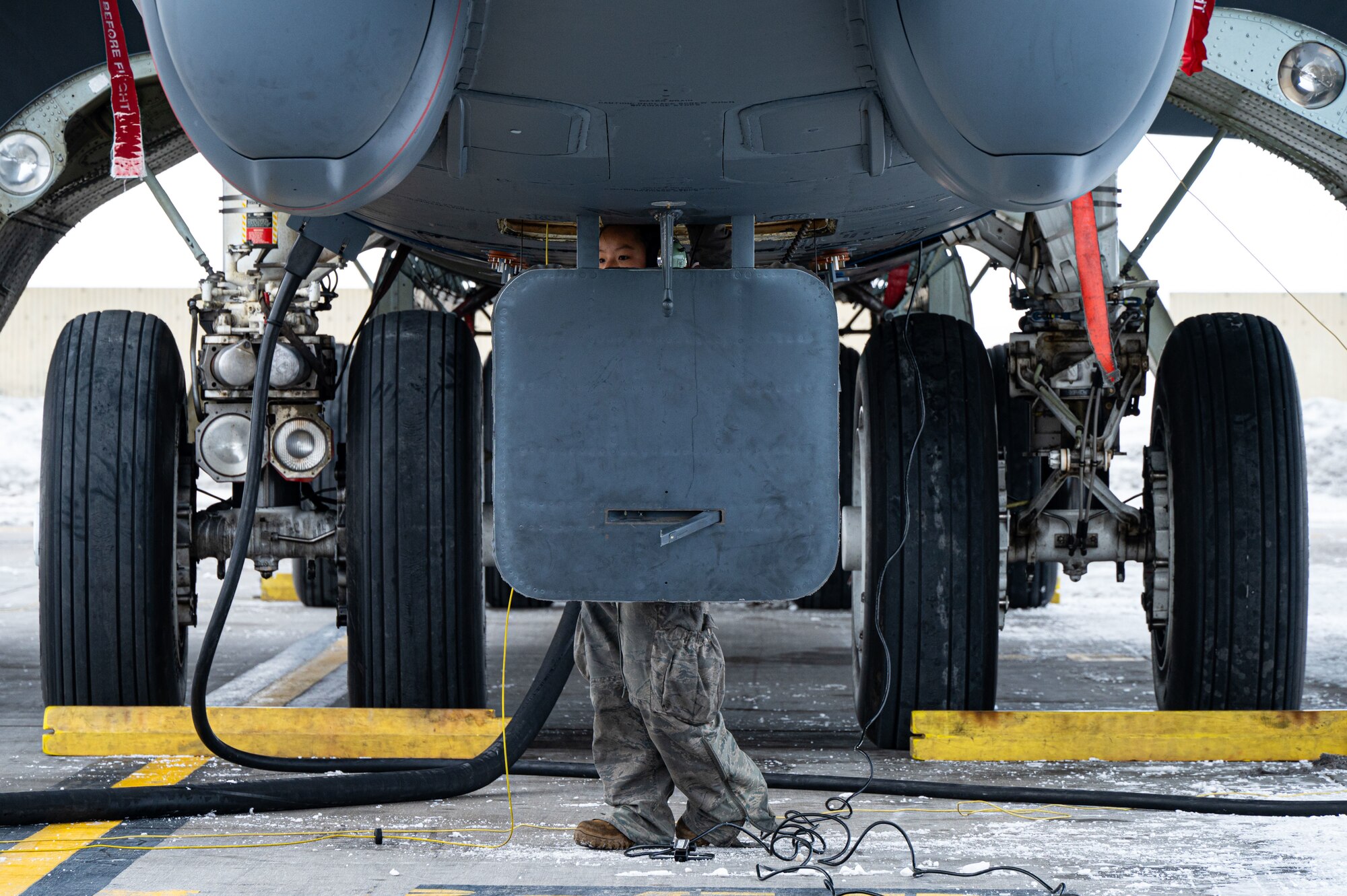 Senior Airman Lily Nicholson, B-52H crew chief apprentice assigned to the 5th Aircraft Maintenance Squadron (5th AMXS), conducts a B-52H Stratofortress refuel at Minot Air Force Base, North Dakota, Jan. 29, 2025. The 5th AMXS Airmen refuel aircraft and ground vehicles, as well as ensure the quality of the fuel. (U.S. Air Force photo by Airman 1st Class Padilla)