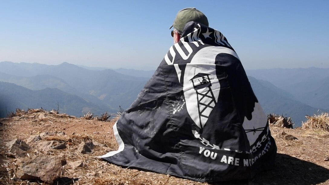 Rick Holland, son of U.S. Air Force Tech. Sgt. Melvin Holland, sits on the summit of Phou Pha Thi during a visit to Laos, Jan. 24, 2025.