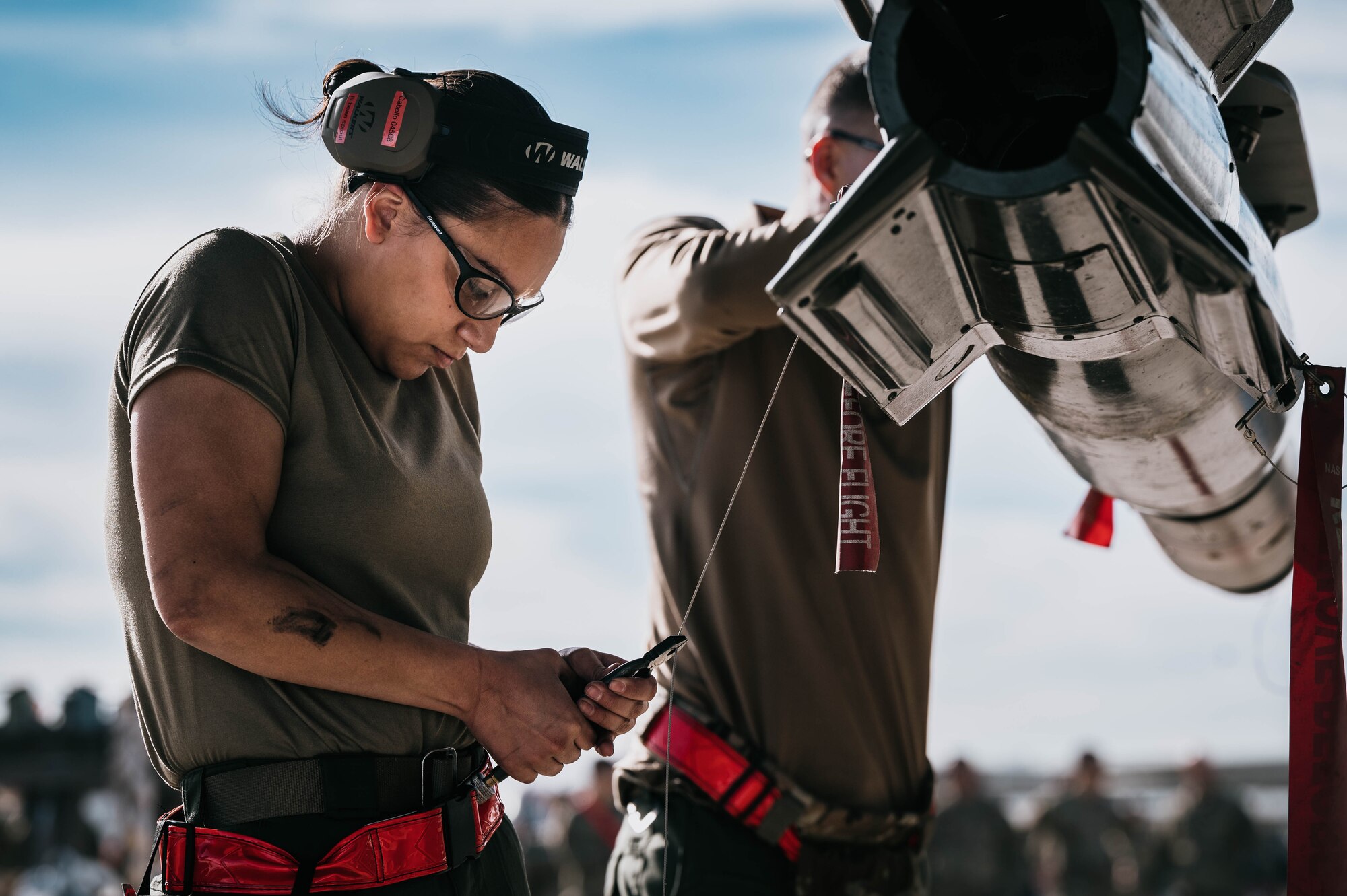 U.S. Air Force Senior Airman Angelina Cabello, 944th Aircraft Maintenance Squadron armament systems specialist, prepares a GBU-12 Paveway II bomb.