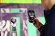 Someone is taking a picture of the Vince Lombardi Trophy using their cell phone.