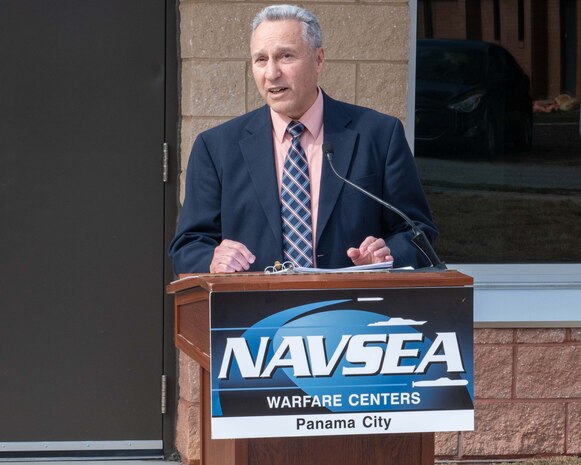 Dr. Joseph Lopes, Naval Surface Warfare Center Panama City Division Subsea and Seabed Warfare and Maritime Operations Department deputy, addresses the crowd before the ceremonial ribbon-cutting of Naval Surface Warfare Center Panama City Division's new Acoustic Test Facility and Instrumentation building, Feb. 5. Lopes was one of the visionaries behind this state-of-the-art facility. (U.S. Navy photo by Eddie Green)