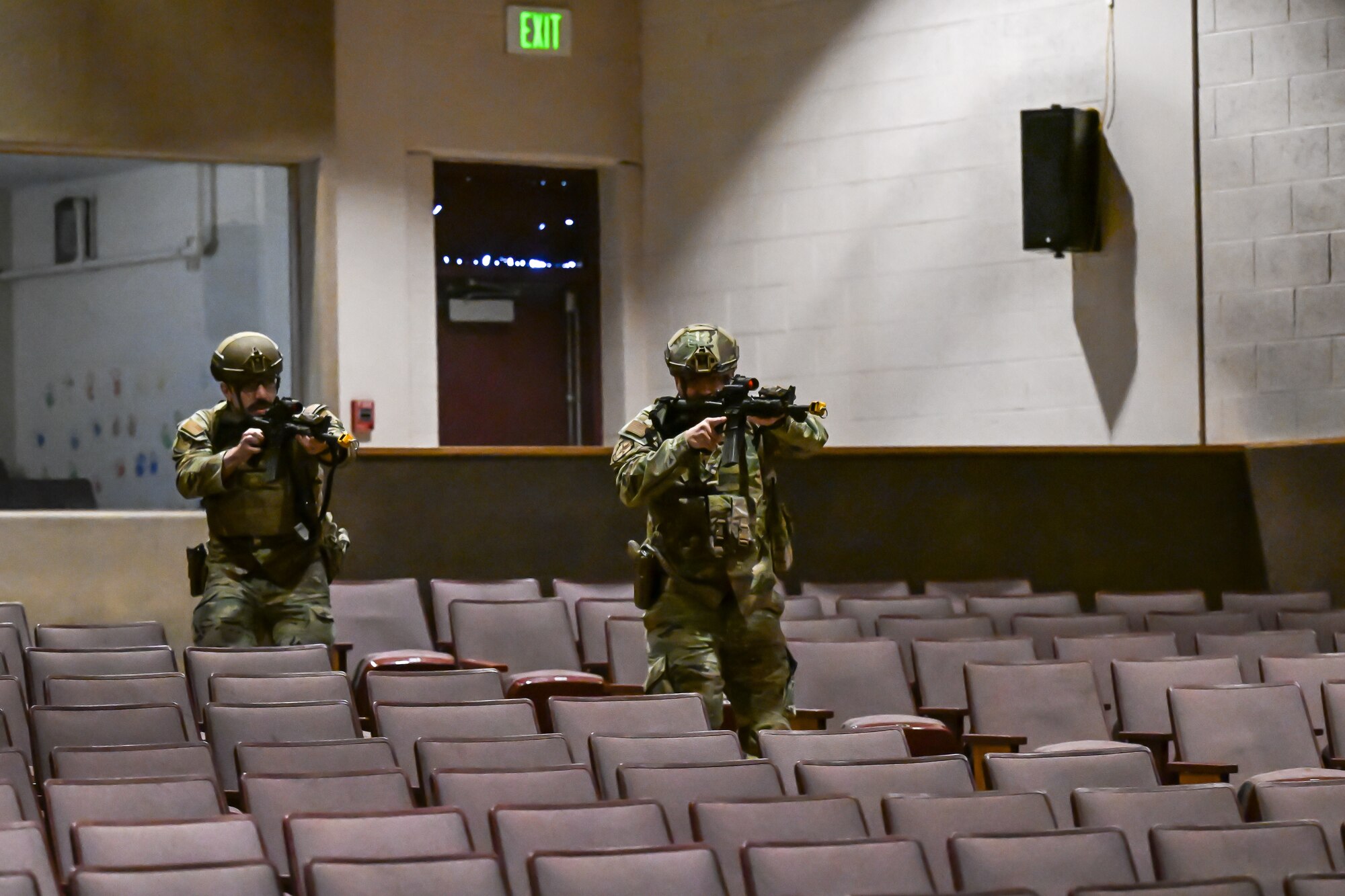 Security forces airman rush through a movie theater to apprehend a simulated armed assailant.