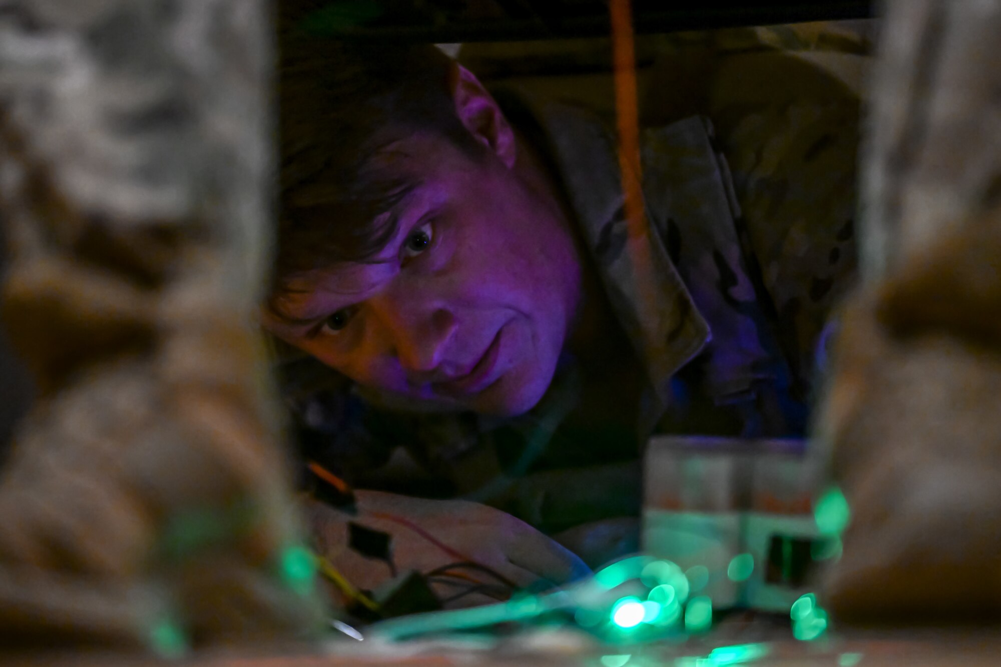 An Airman examines a mock explosive during an exercise