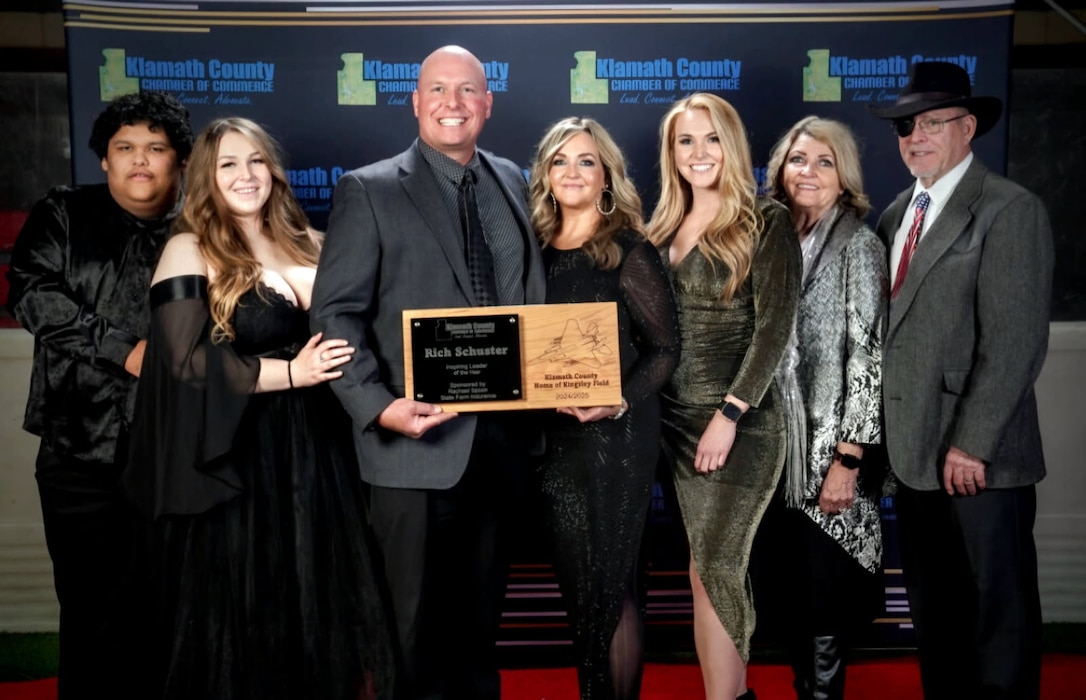 People pose with a plaque for a picture