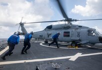 SOUTH CHINA SEA (Feb. 6, 2025) Sailors assigned to the Arleigh Burke-class guided missile destroyer USS Benfold (DDG 65), support flight operations for a Royal Australian Navy MH-60R Seahawk helicopter on Benfold’s flight deck during multilateral operations with Australia and the United Kingdom in the South China Sea, Feb. 6. Benfold is forward deployed and assigned to Destroyer Squadron (DESRON) 15, the Navy’s Largest DESRON and U.S. 7th Fleet’s principal surface force. (U.S. Navy Photo by Mass Communication Specialist 2nd Class Monica Walker.)