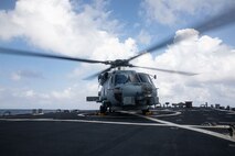 SOUTH CHINA SEA (Feb. 6, 2025) A Royal Australian Navy MH-60R Seahawk helicopter lands on the flight deck of the Arleigh Burke-class guided missile destroyer USS Benfold (DDG 65) during multilateral operations with Australia and the United Kingdom in the South China Sea, Feb. 6. Benfold is forward deployed and assigned to Destroyer Squadron (DESRON) 15, the Navy’s Largest DESRON and U.S. 7th Fleet’s principal surface force. (U.S. Navy Photo by Mass Communication Specialist 2nd Class Monica Walker.)