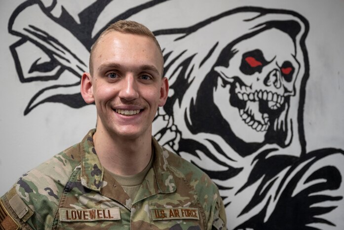 U.S. Air Force 2nd Lt. Nathan Lovewell, 35th Logistics Readiness Squadron (LRS) asset management officer in charge, poses for a photograph in front of a mural of the 35th LRS mascot.