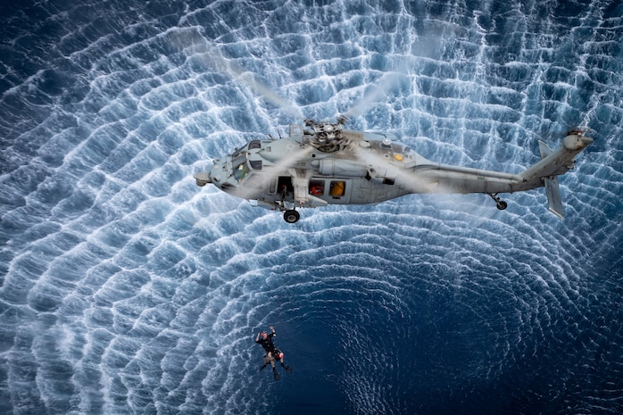 An MH-60S Seahawk, assigned to the “Black Knights” of Helicopter Sea Combat Squadron (HSC) 4, conducts search and rescue training with Sailors assigned to the Nimitz-class aircraft carrier USS Carl Vinson (CVN 70) Feb. 7, 2025.