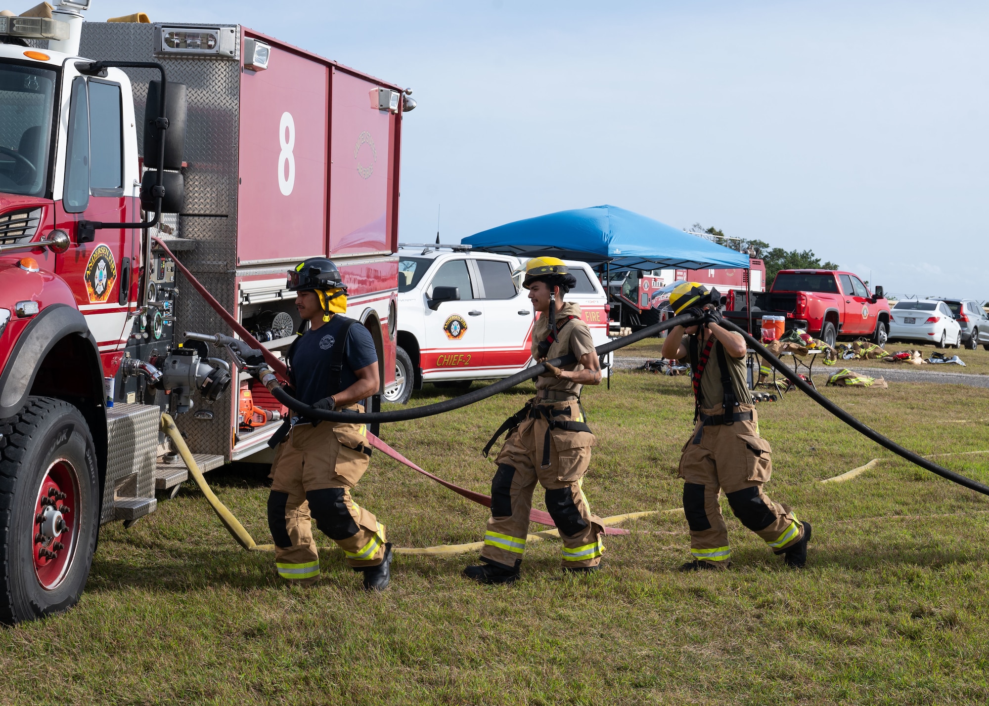 U.S. Air Force Airmen assigned to the 36th Civil Engineer Squadron, work to put out a live fire as part of a Rookie Book Academy training exercise at Andersen Air Force Base, Guam, Feb. 6, 2025.The purpose of this training was to prepare first-term Airmen for real-life fire emergencies. (U.S. Air Force photo by Airman 1st Class Joseph Maye)