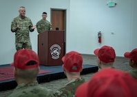 Gallagher stands on low stage and talks with audience