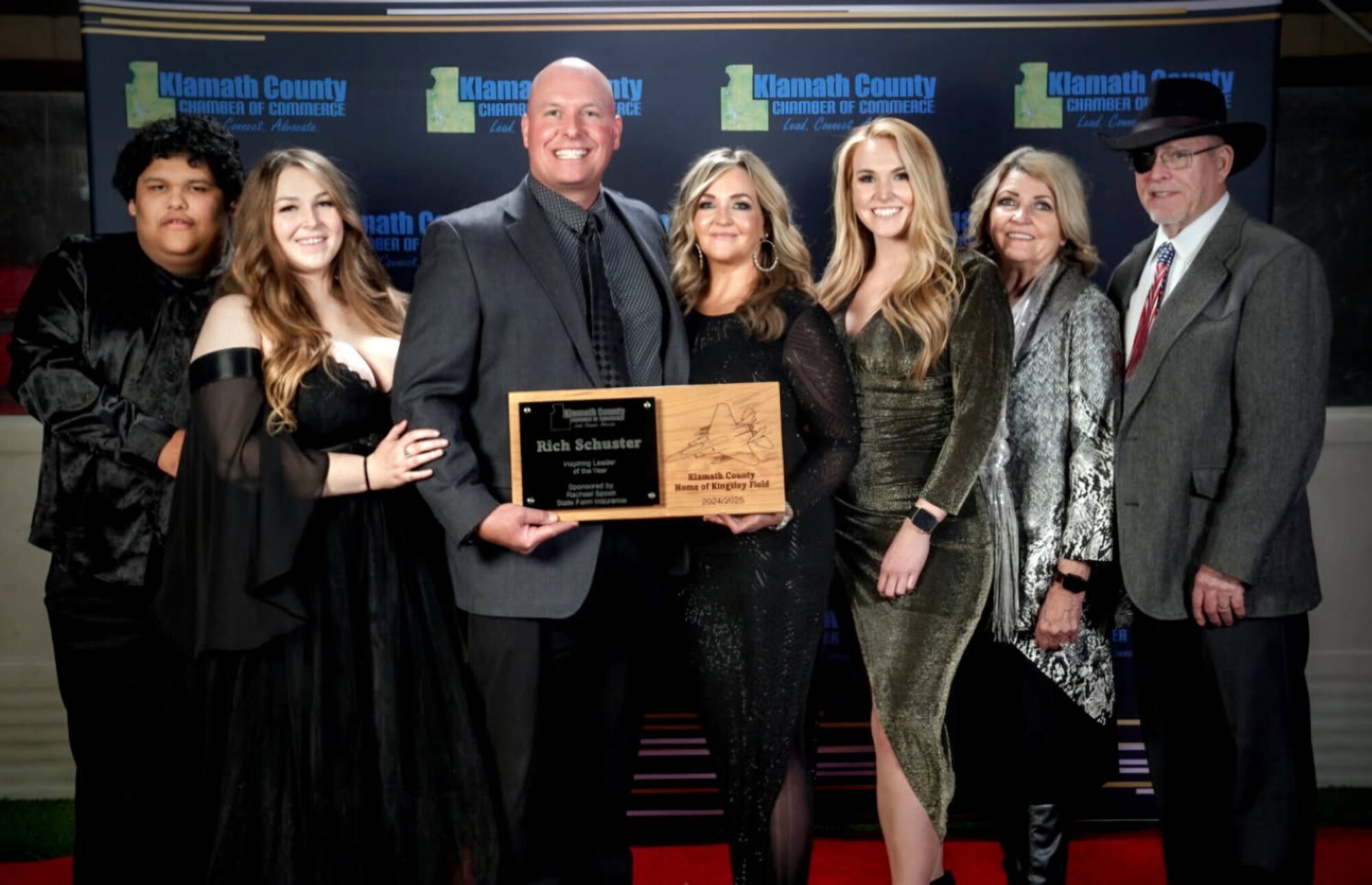 People pose with a plaque for a picture