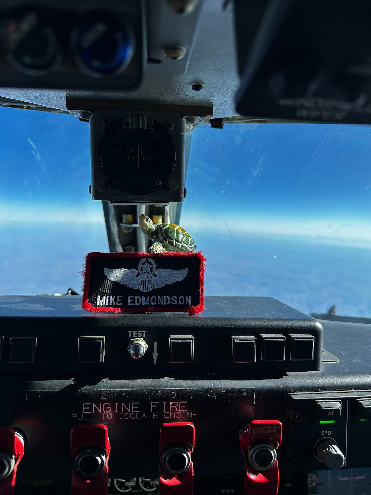 A nametape rests on equipment in the cockpit of an aircraft during a flight