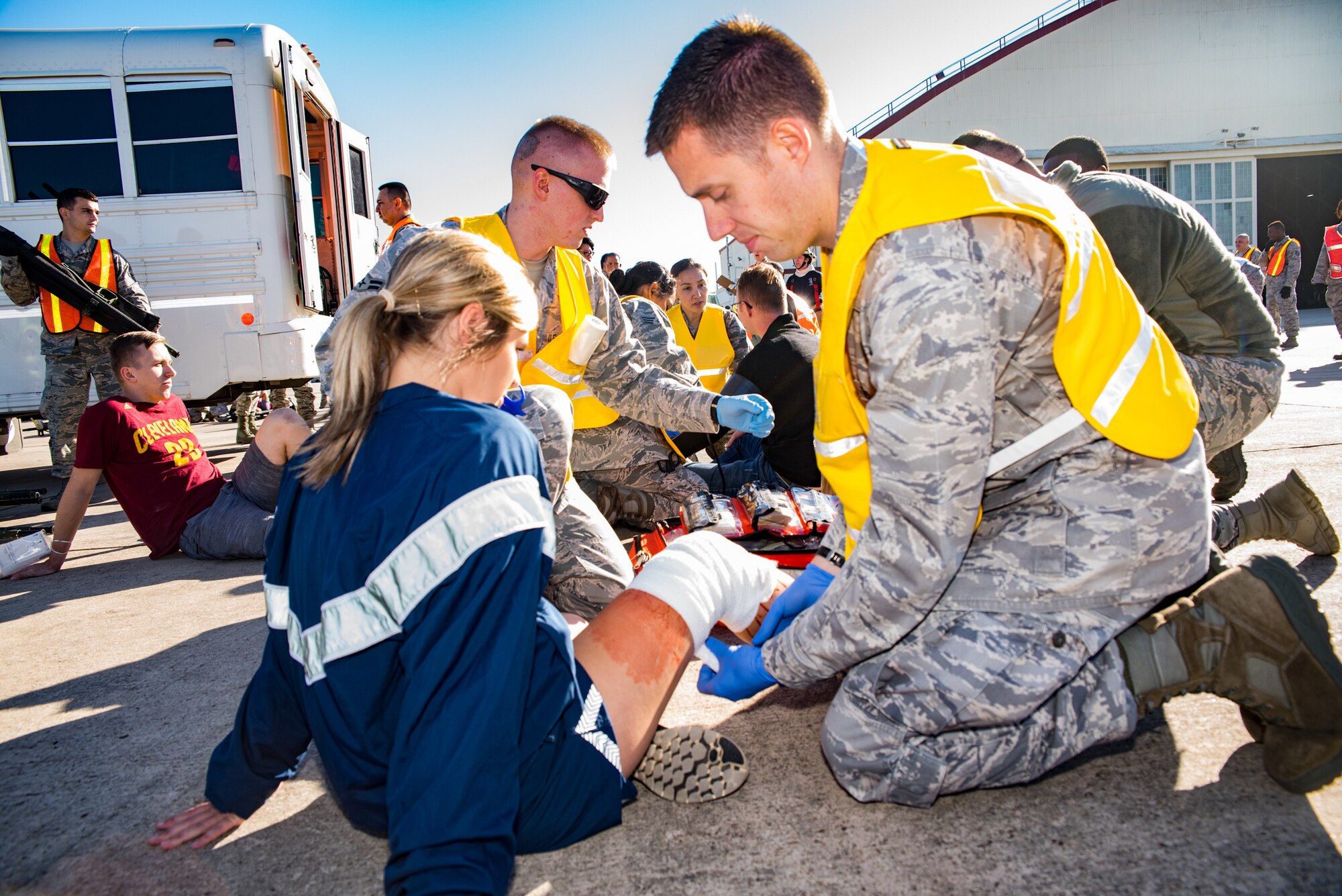 Military member assisting exercise simulated victim.