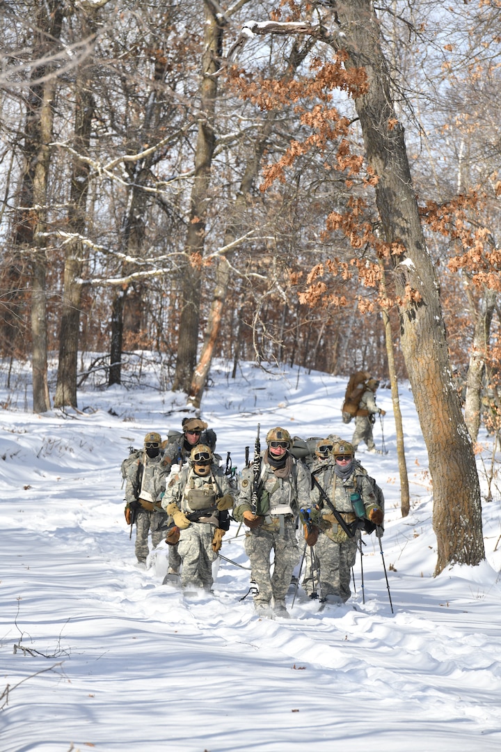 A team of Air National Guard airmen ruck march on snowshoes while using land navigational skills after sleeping in a thermal shelter on the fourth night of a six-day, five-night Field Training Exercise during the Air National Guard's Cold Weather Operations Course at Camp Ripley Training Center, Minn., Feb. 6, 2025. 70 class participants representing 37 wings from 27 states traveled on foot in subzero temperatures, to build camps featuring either a 10-man Arctic tent or thermal shelters made from materials found in nature. Students were comprised of mostly Security Forces specialists, but also included a Maintenance Group Commander, Physician Assistant, Cyber Communications Specialist, and a Public Affairs Specialist. The course taught service members to conduct mission-essential tasking in extreme cold environments.