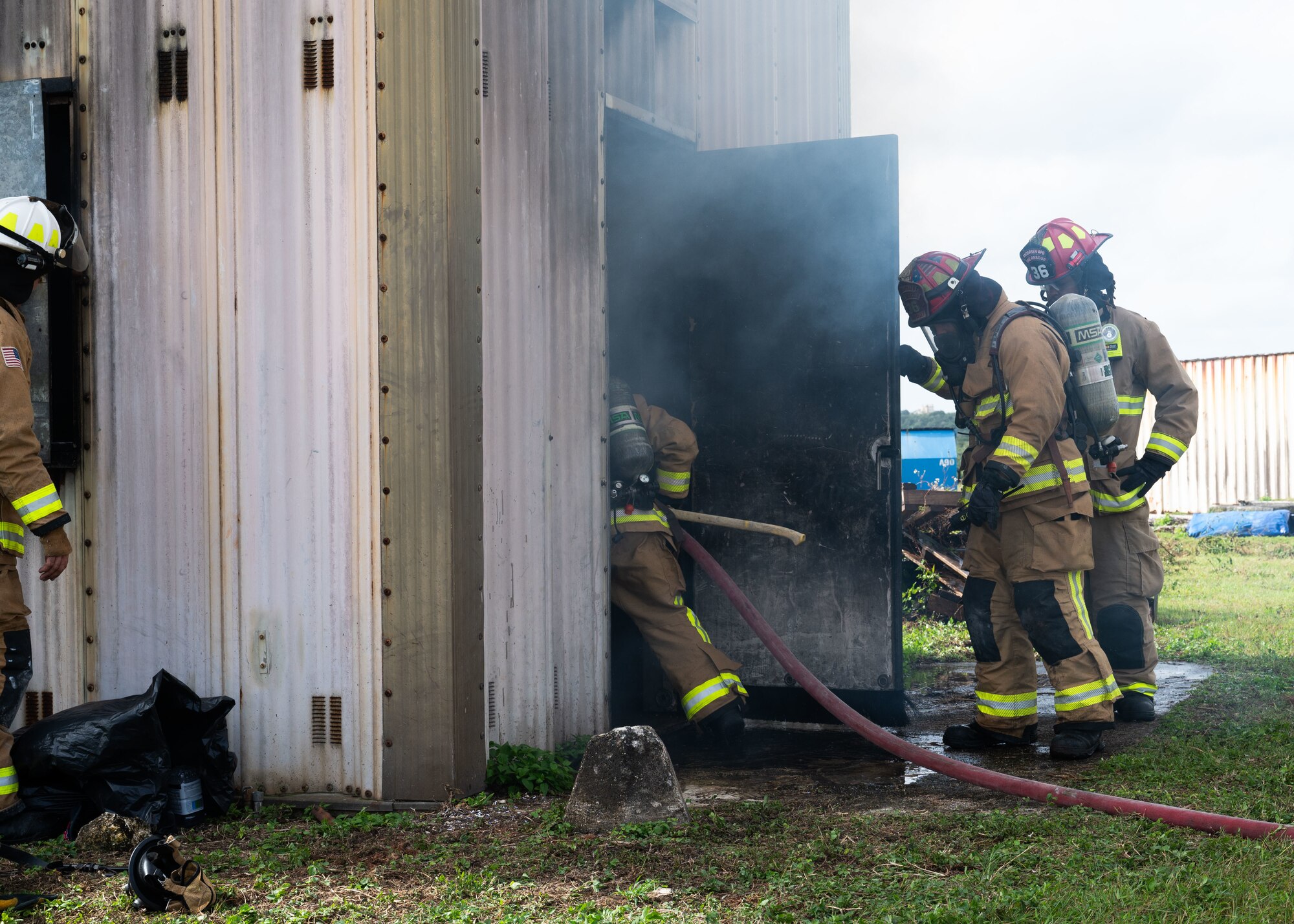 U.S. Air Force Airmen assigned to the 36th Civil Engineer Squadron, work to put out a live fire as part of a Rookie Book Academy training exercise at Andersen Air Force Base, Guam, Feb. 6, 2025.The purpose of this training was to prepare first-term Airmen for real-life fire emergencies. (U.S. Air Force photo by Airman 1st Class Joseph Maye)