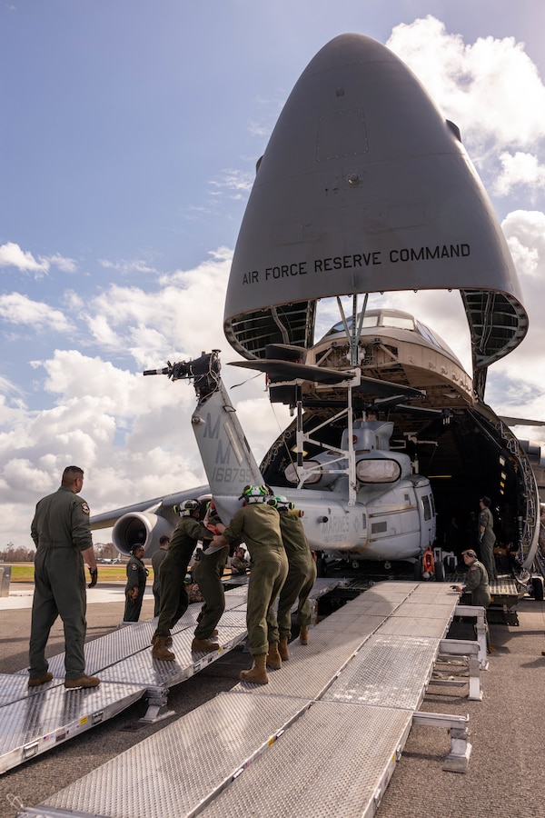 U.S. Marines and U.S. Airmen load a UH-1Y Venom helicopter onto a C-5 Super Galaxy aircraft during a static load exercise at Naval Air Station Joint Reserve Base New Orleans, Belle Chasse, Louisiana, Feb. 6, 2025. Marine Light Attack Helicopter Squadron (HMLA) 773, 4th Marine Aircraft Wing, Marine Forces Reserve, trained alongside U.S. Airmen, 26th Aerial Port Squadron, 68th Airlift Squadron to mentor and develop the next generation of logisticians, while fostering cross service knowledge and collaboration between Air Force and Marine Corps teams. (U.S. Marine Corps photo by Sgt. Emely Gonzalez)