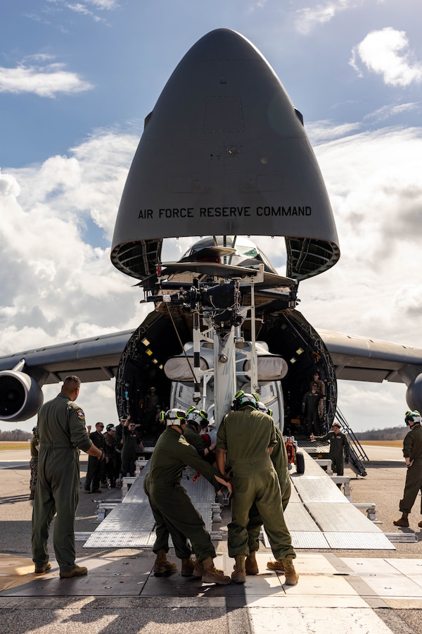 U.S. Marines and U.S. Airmen load a UH-1Y Venom helicopter onto a C-5 Super Galaxy aircraft during a static load exercise at Naval Air Station Joint Reserve Base New Orleans, Belle Chasse, Louisiana, Feb. 6, 2025. Marine Light Attack Helicopter Squadron (HMLA) 773, 4th Marine Aircraft Wing, Marine Forces Reserve, trained alongside U.S. Airmen, 26th Aerial Port Squadron, 68th Airlift Squadron, to mentor and develop the next generation of logisticians, while fostering cross service knowledge and collaboration between Air Force and Marine Corps teams. (U.S. Marine Corps photo by Sgt. Emely Gonzalez)