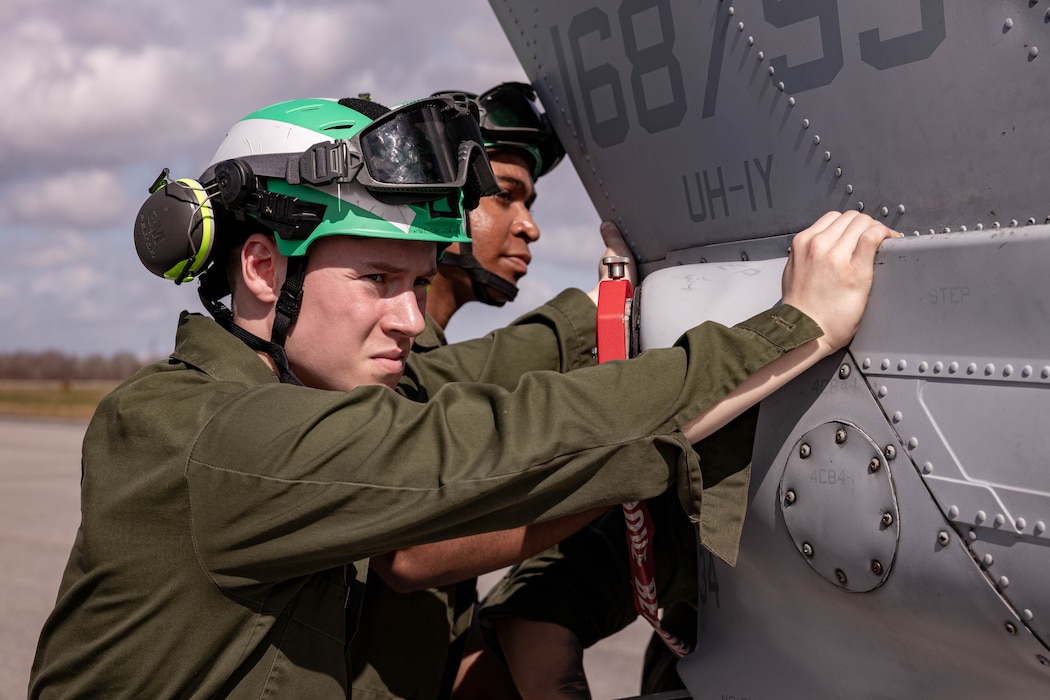 U.S. Marine Corps Cpl. Joseph Poeppelmeier, airframe technician prepares to load a UH-1Y Venom helicopter during a C-5 Super Galaxy aircraft static load exercise at Naval Air Station Joint Reserve Base New Orleans, Belle Chasse, Louisiana, Feb. 6, 2025. Poeppelmeier with Marine Light Attack Helicopter Squadron (HMLA) 773, 4th Marine Aircraft Wing, Marine Forces Reserve, trained alongside U.S. Airmen, 26th Aerial Port Squadron, 68th Airlift Squadron, to mentor and develop the next generation of logisticians, while fostering cross service knowledge and collaboration between Air Force and Marine Corps teams. (U.S. Marine Corps photo by Sgt. Emely Gonzalez)