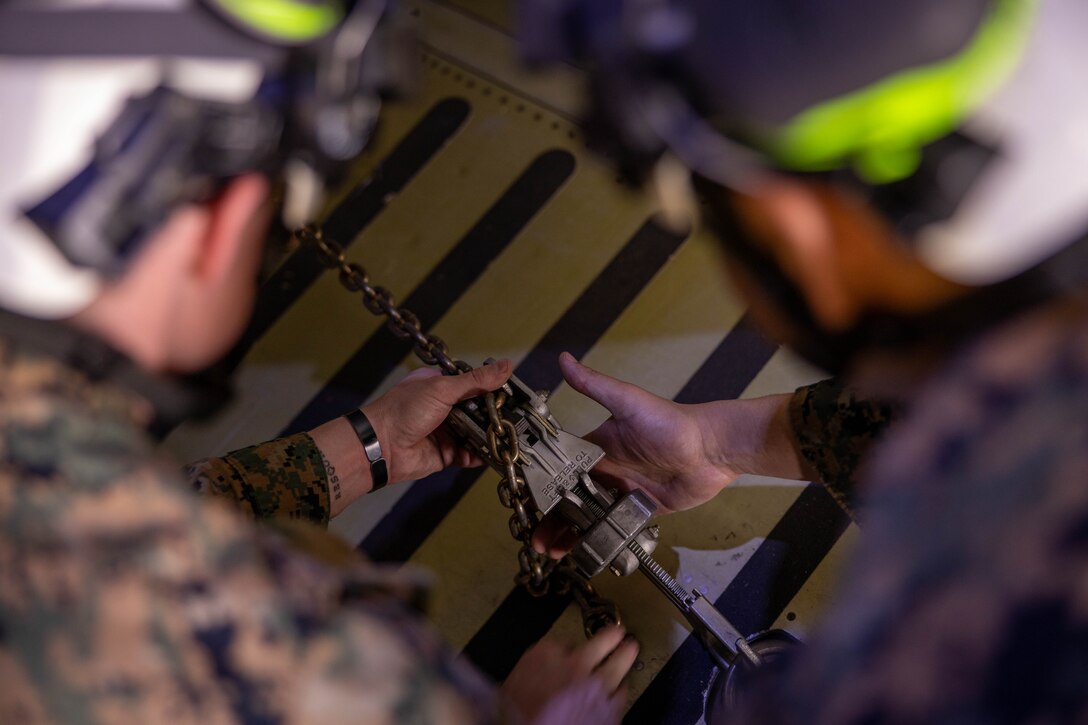 U.S. Marines secure a UH-1Y Venom helicopter onto a C-5 Super Galaxy during a static load exercise at Naval Air Station Joint Reserve Base New Orleans, Belle Chasse, Louisiana, Feb. 6, 2025. Marine Light Attack Helicopter Squadron (HMLA) 773, 4th Marine Aircraft Wing, Marine Forces Reserve, train alongside U.S. Airmen, 26th Aerial Port Squadron, 68th Airlift Squadron, to mentor and develop the next generation of logisticians, while fostering cross service knowledge and collaboration between Air Force and Marine Corps teams. (U.S. Marine Corps photo by Sgt. Emely Gonzalez)