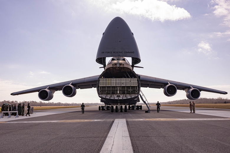 U.S. Airmen prepare to drop the loading dock of a C-5 Super Galaxy aircraft during a static load exercise at Naval Air Station Joint Reserve Base New Orleans, Belle Chasse, Louisiana, Feb. 6, 2025. Marine Light Attack Helicopter Squadron (HMLA) 773, 4th Marine Aircraft Wing, Marine Forces Reserve, trained alongside U.S. Airmen, 26th Aerial Port Squadron, 68th Airlift Squadron, to mentor and develop the next generation of logisticians, while fostering cross service knowledge and collaboration between Air Force and Marine Corps teams. (U.S. Marine Corps photo by Sgt. Emely Gonzalez)
