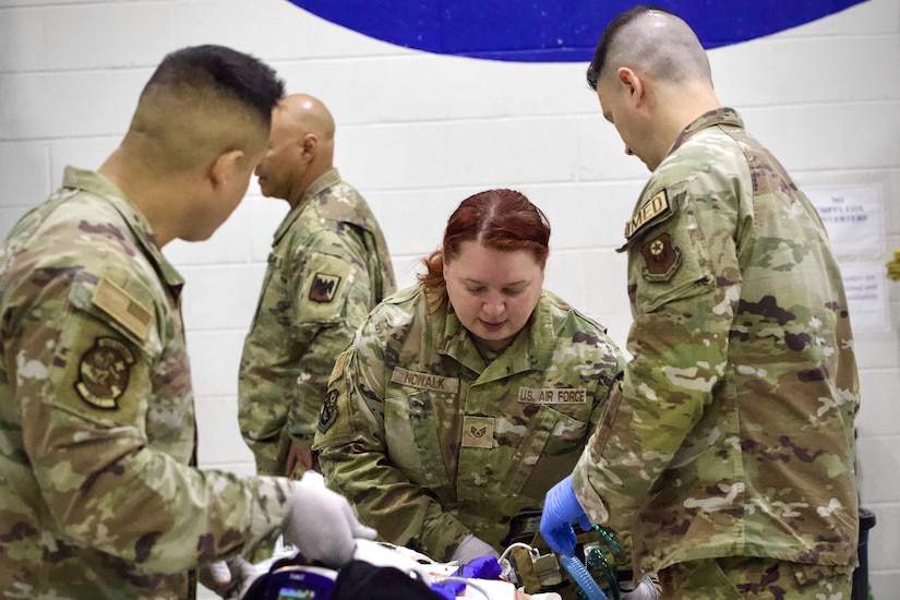 From left, U.S. Air Force Tech. Sgt. Carlos Patino, Tech. Sgt. Suzanne and Capt. Steven Thompson, assigned to Detachment 1, Medical Group, 193rd Special Operations Wing, Pennsylvania National Guard, perform lifesaving techniques on simulated patients during a mass casualty exercise at Penn State Health Milton S. Hershey Medical Center in Hershey, Pennsylvania, Feb. 7, 2025. These Airmen are nurses or medics who completed an inaugural two-week training program, which is a new partnership between the National Guard and MSHMC, where participants learn how to respond effectively in emergencies and combat situations. (U.S. Army National Guard photo by Maj. Travis Mueller)